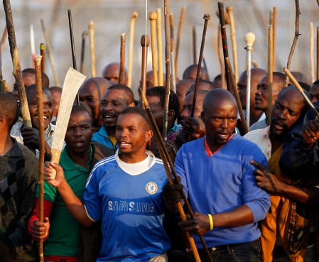 Striking miners chant slogans outside a South African mine in Rustenburg